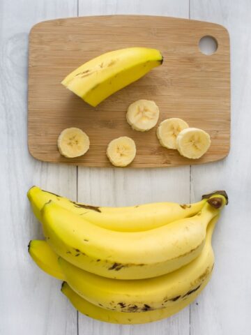 ripe bananas on cutting board