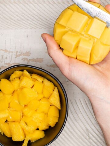 cutting a mango with a knife