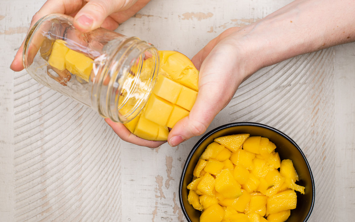 peeling mango with a glass