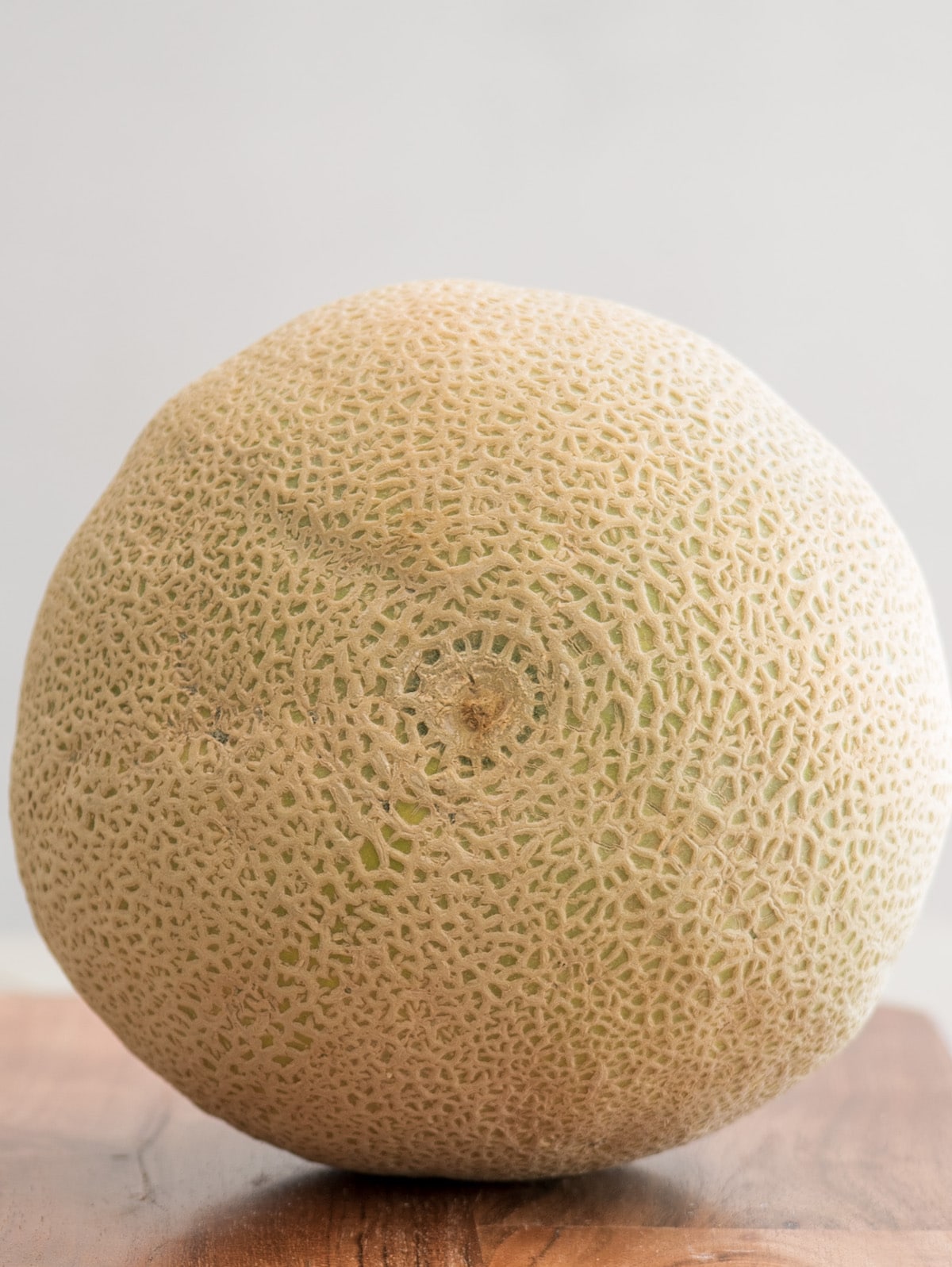 whole cantaloupe on cutting board