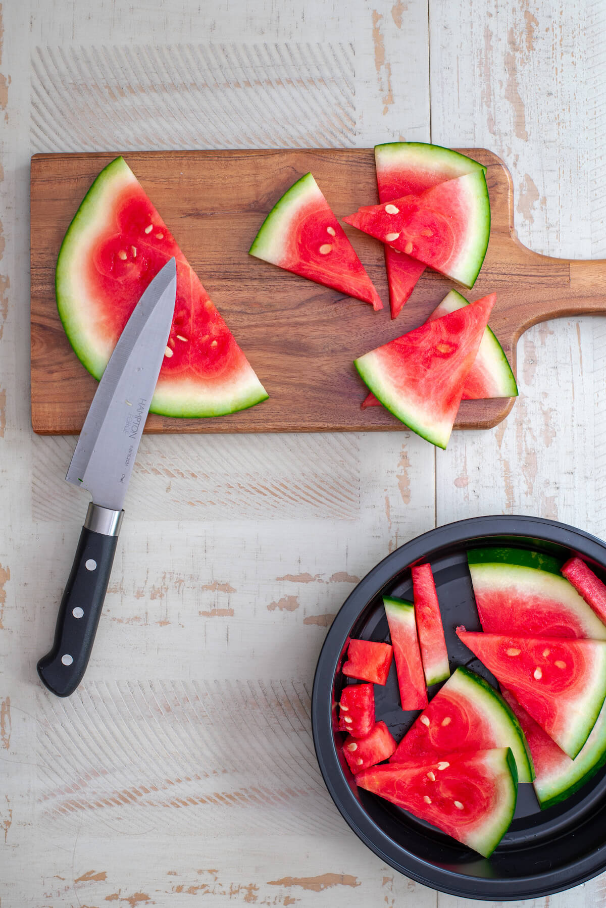 watermelon slices on a cutting board with knife