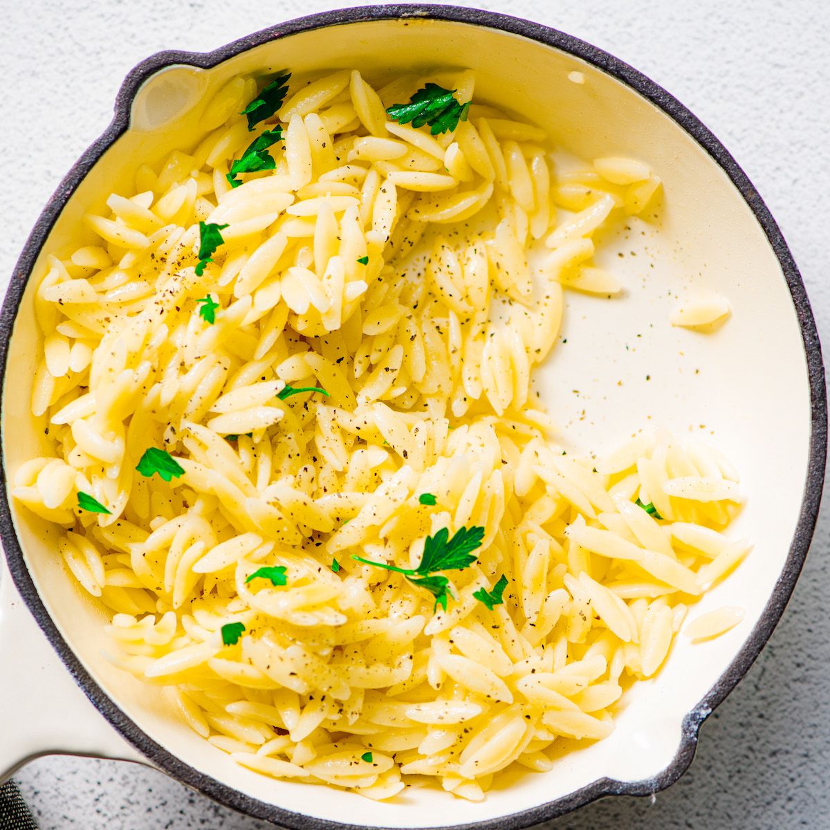 instant pot orzo with pepper and parsley in baking dish