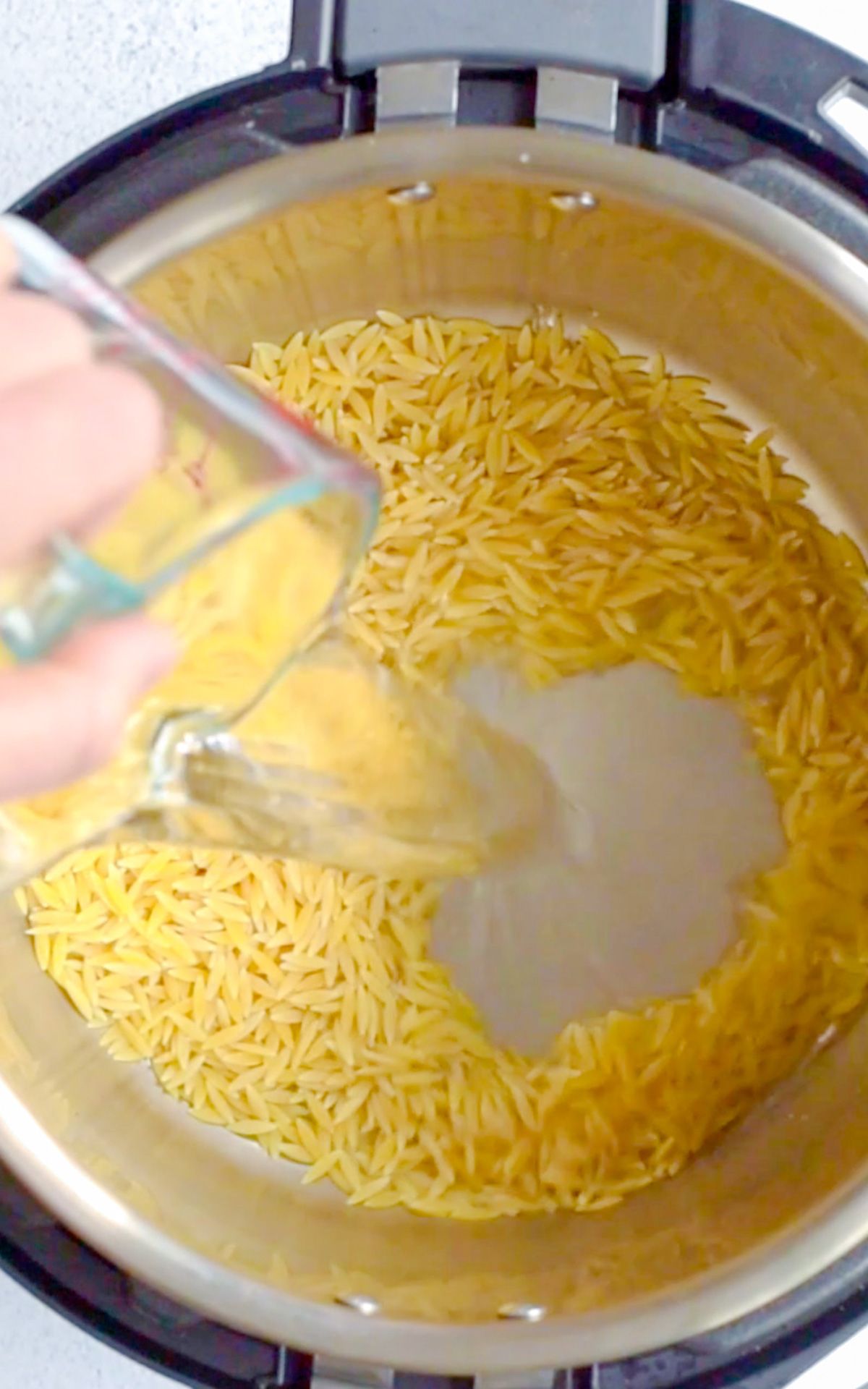 add orzo and water to instant pot