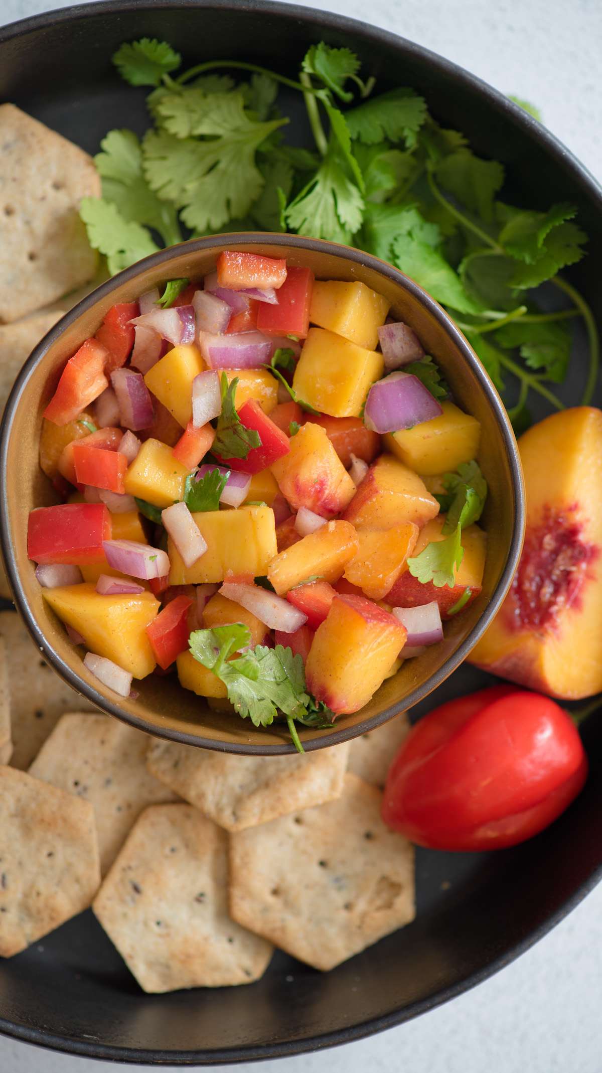 bowl of peach mango salsa over chips