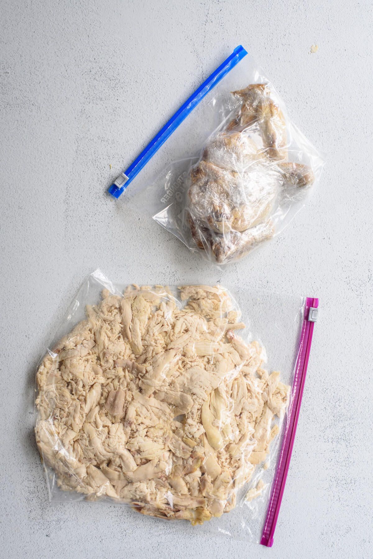ziplock bags filled with shredded rotisserie chicken and chicken parts