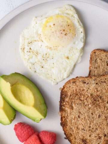 over medium egg with fruit and toast