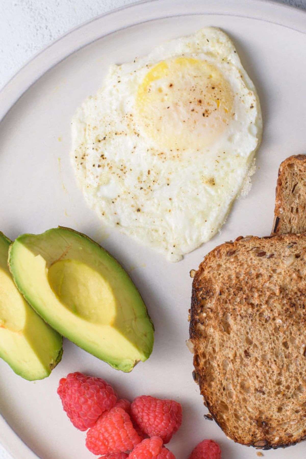 over medium eggs with fruit and toast