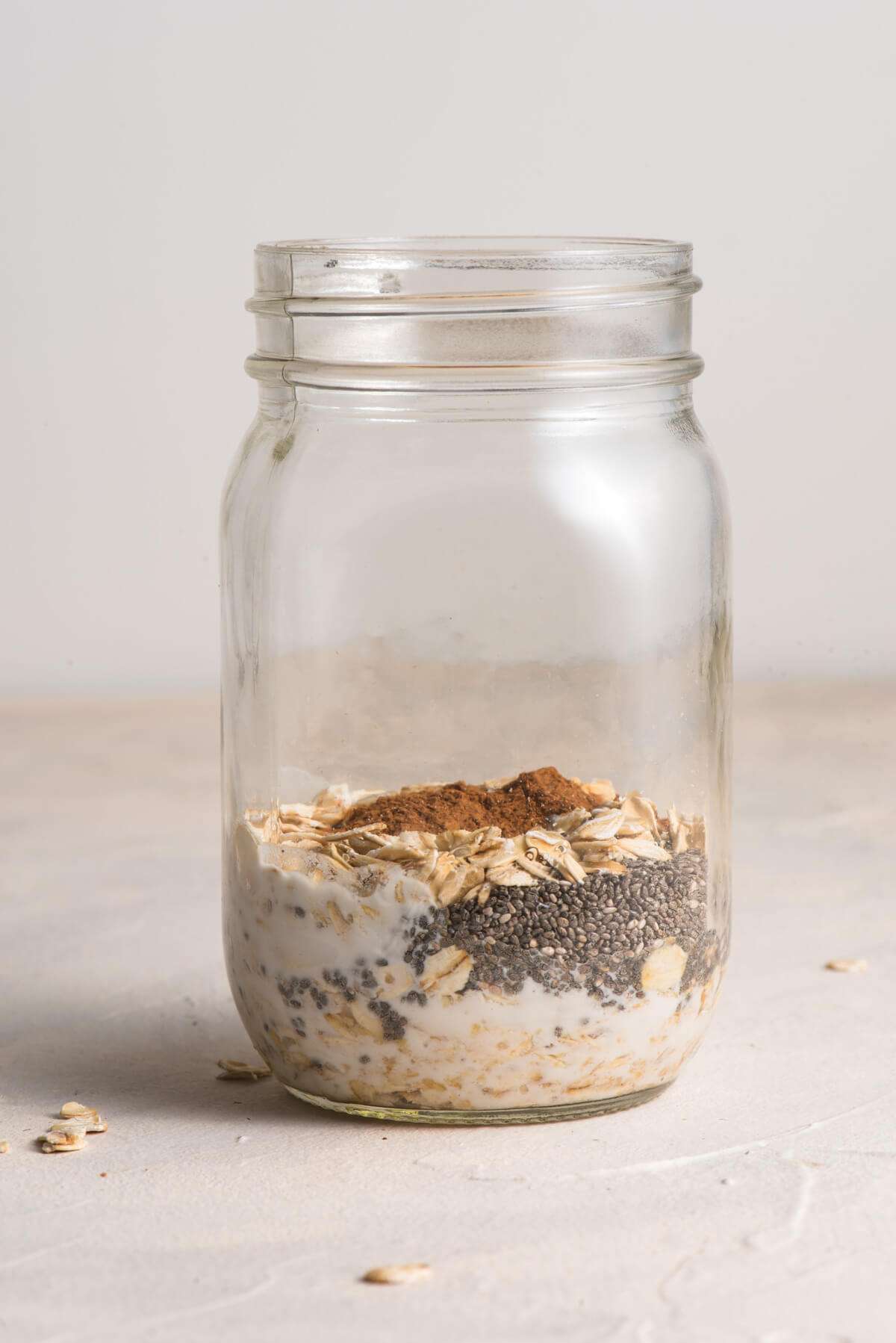 mason jar filled with oats, chia seeds, cinnamon, and water