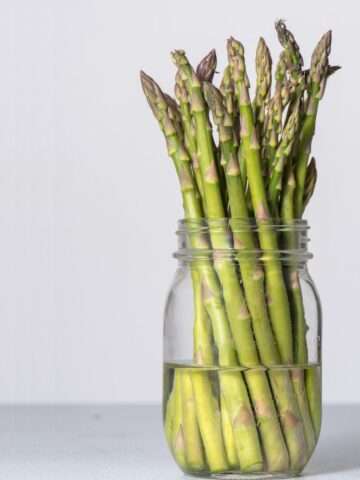 asparagus stalks in a jar of water