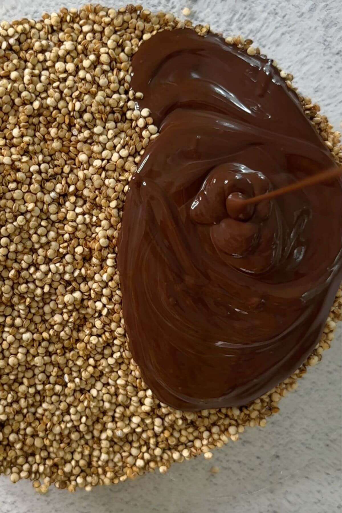 puffed quinoa in a bowl with melted chocolate